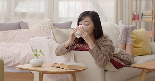 Young Chinese woman reading on sofa,4K