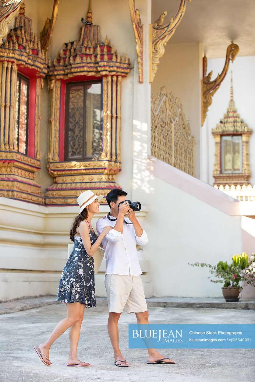 Happy young Chinese couple on vacation in Thailand