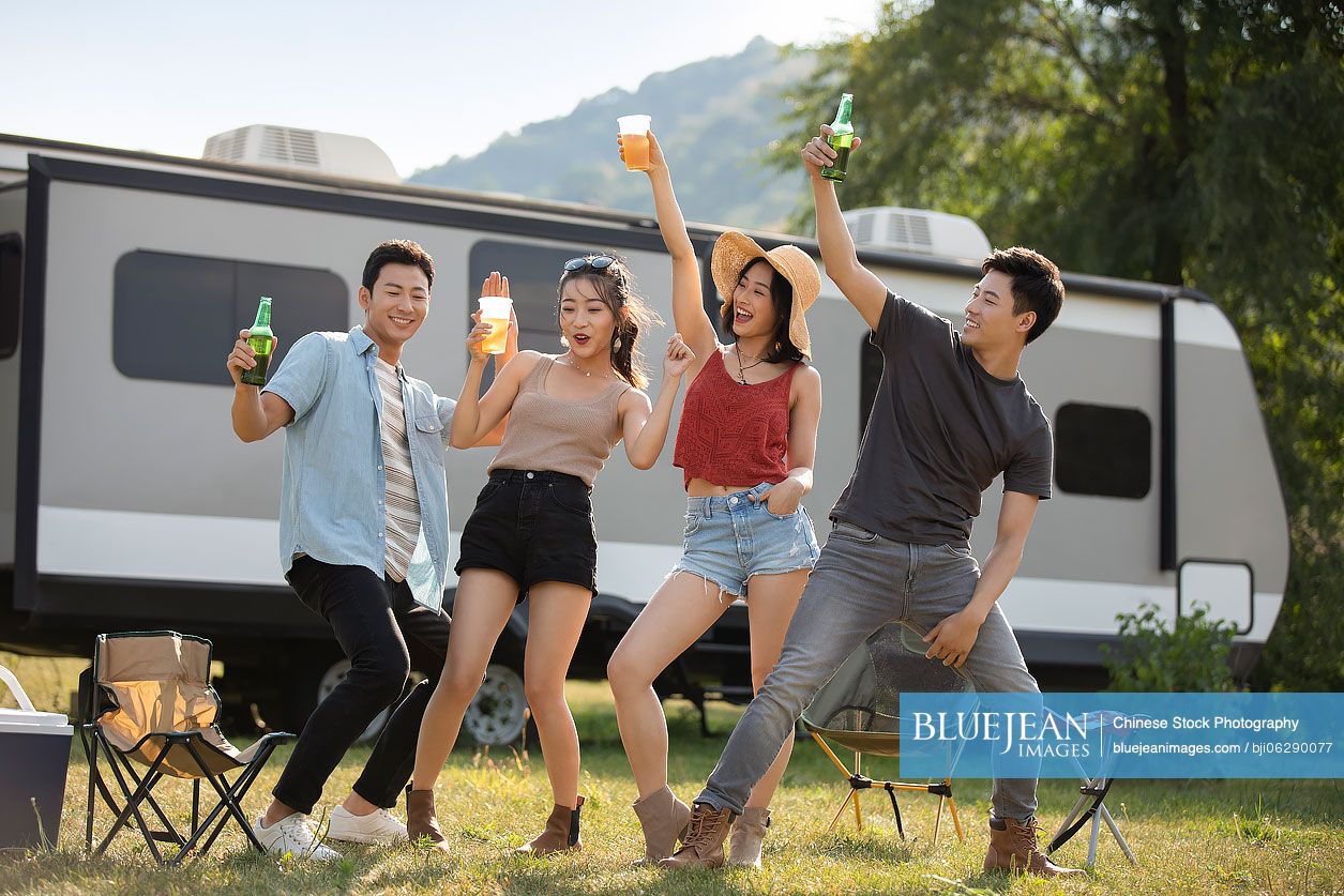 Happy young Chinese friends having fun outdoors