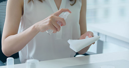 Young Chinese businesswoman using disinfectant in office,4K