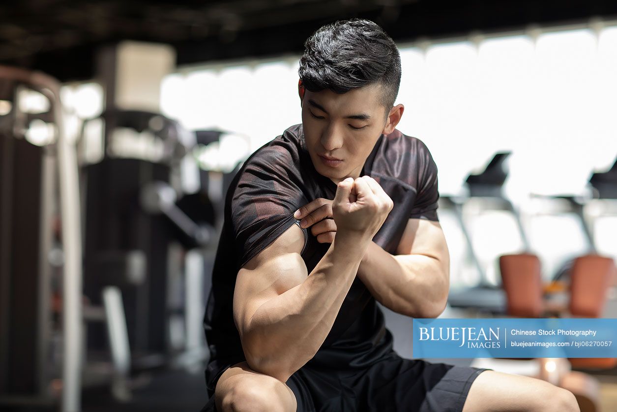 Young Chinese man exercising at gym