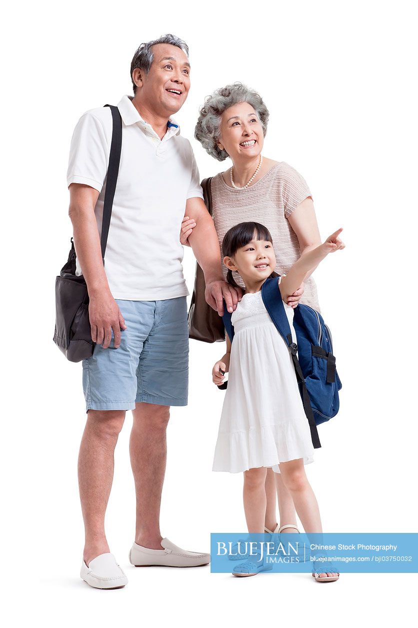 joyful-chinese-grandparents-and-granddaughter-looking-at-view-high-res