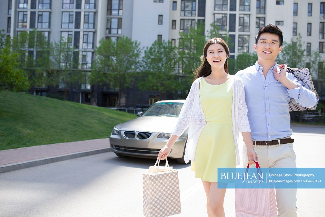 Happy young Chinese couple shopping