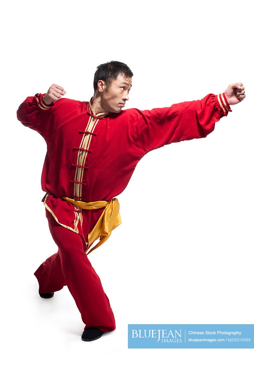 Focused Chinese man doing martial arts in traditional clothing