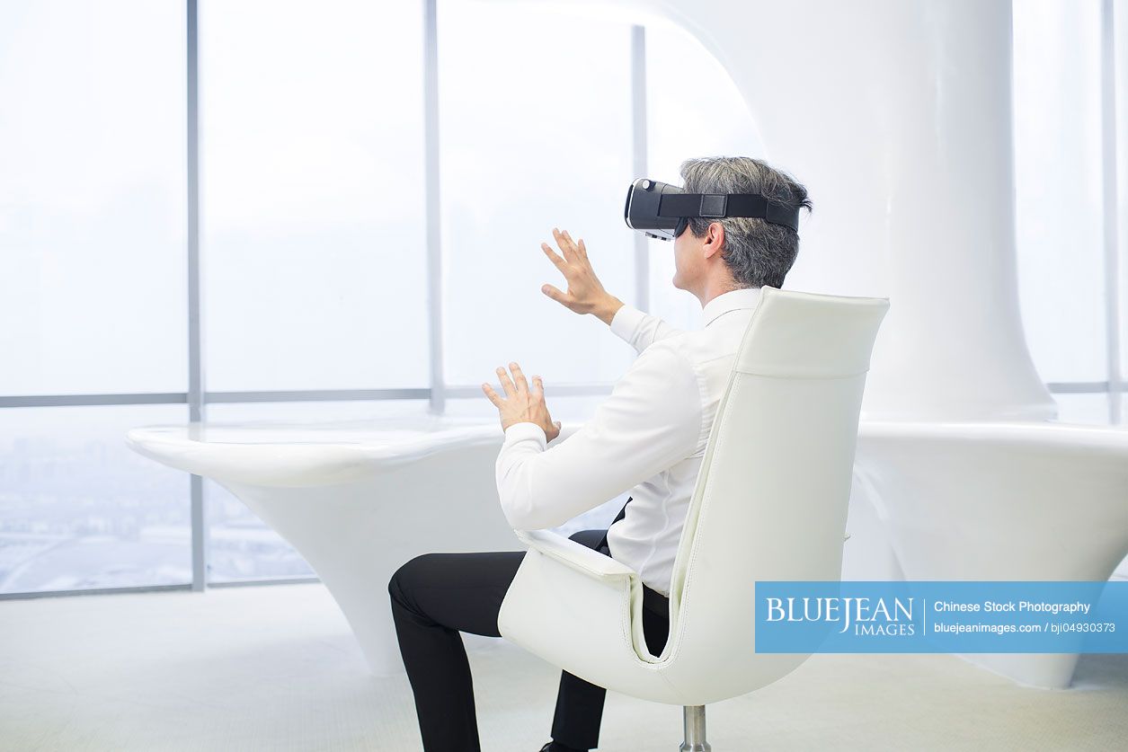 Businessman wearing VR glasses in office