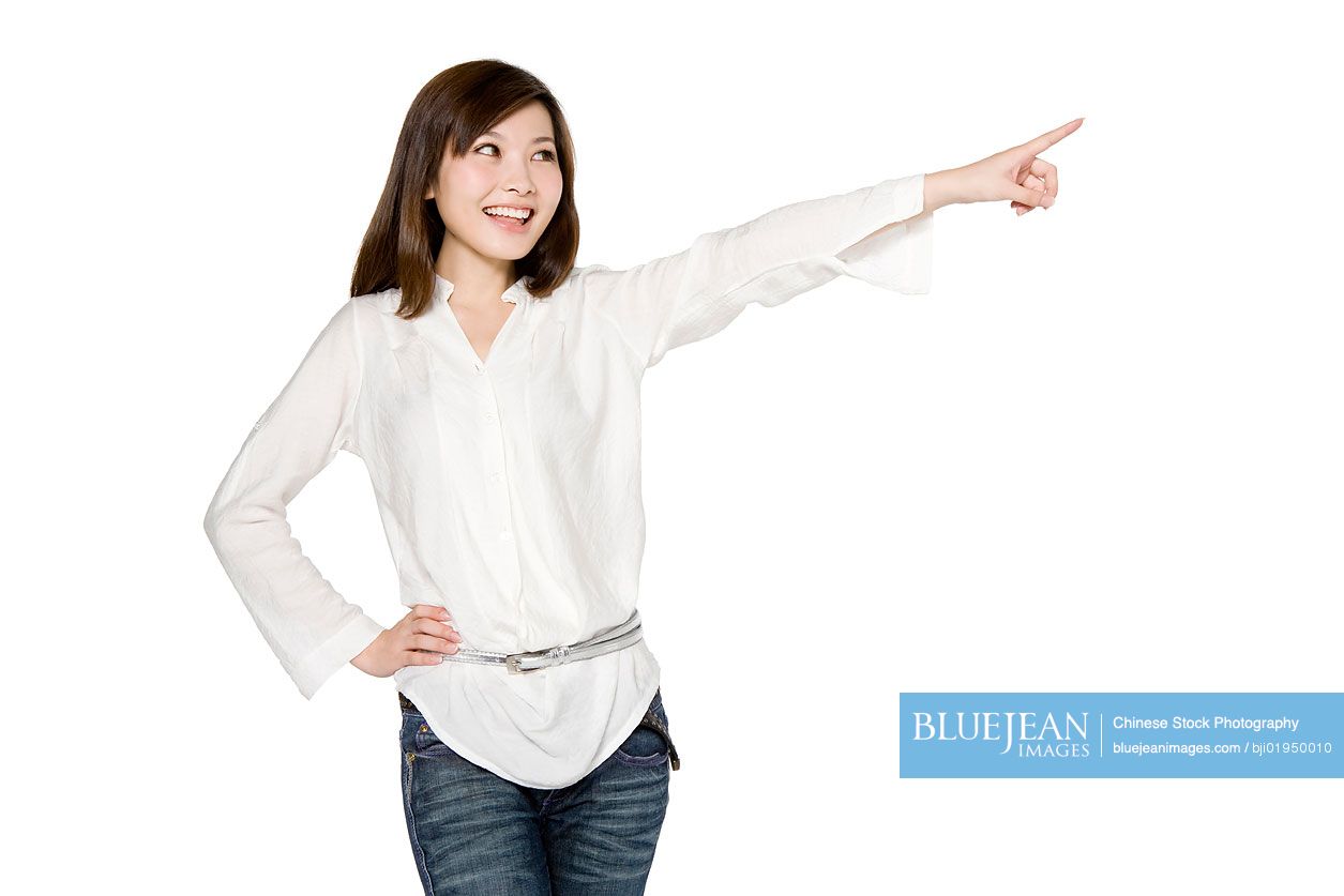Portrait of young Chinese woman pointing