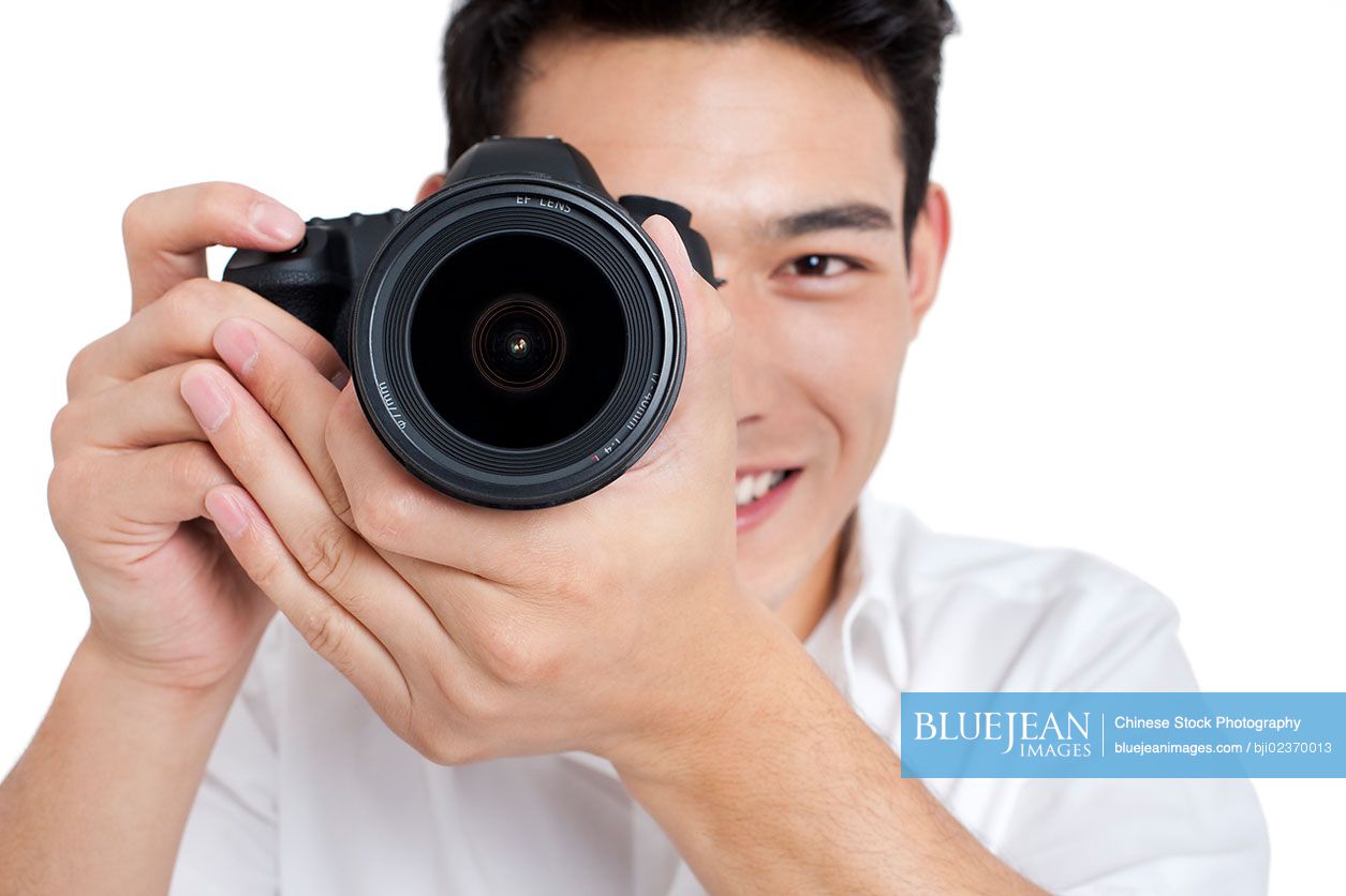 Young Chinese man taking photos