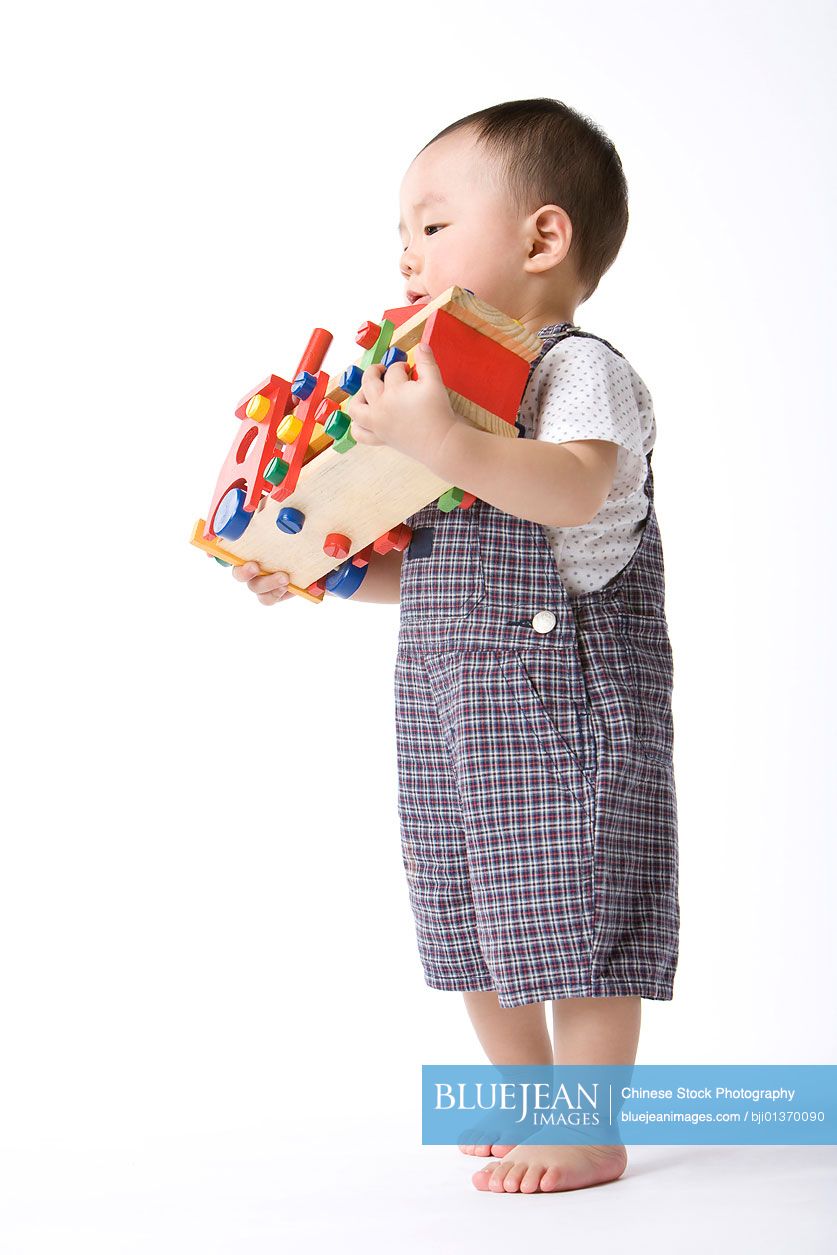 Chinese infant with toy