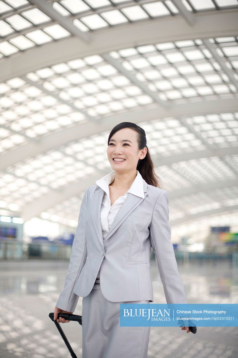 Chinese businesswoman travelling with luggage
