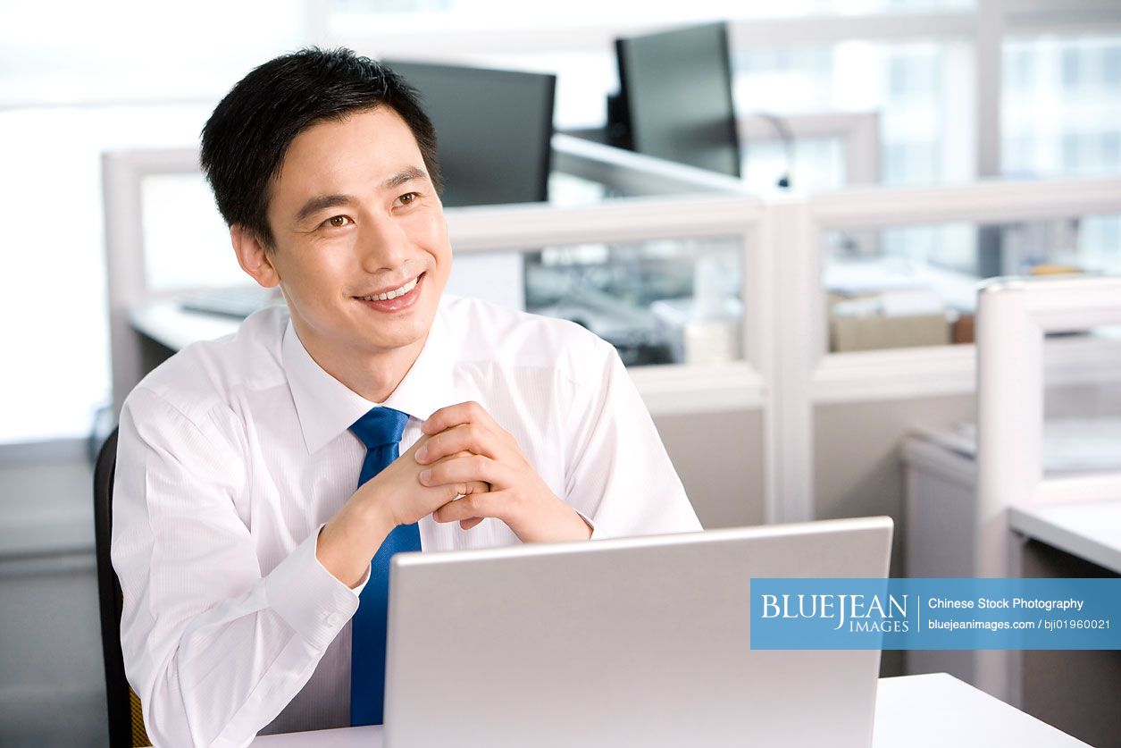 Chinese office worker at his desk