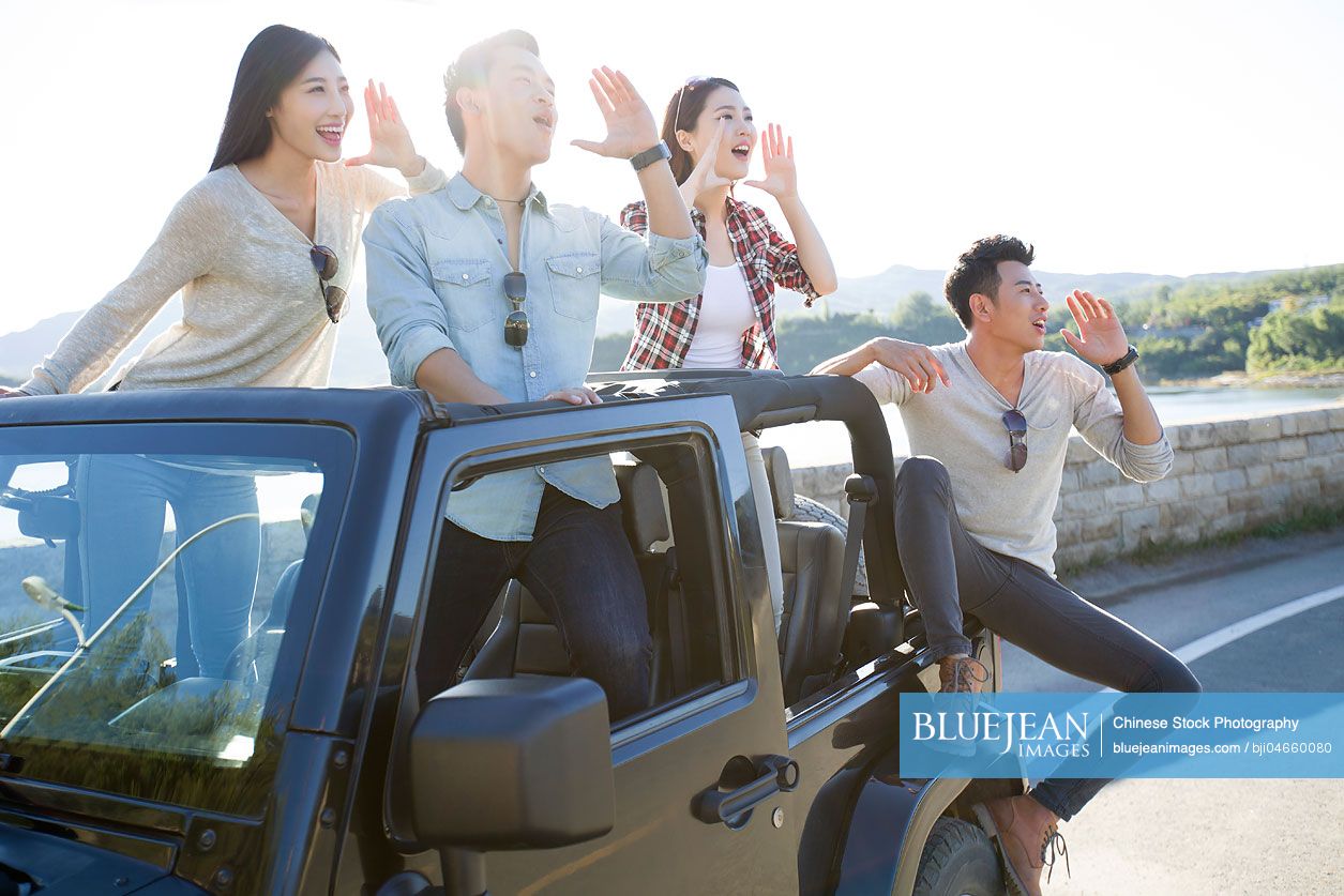 chinese-friends-having-fun-in-a-jeep-high-res-stock-photo-for-download