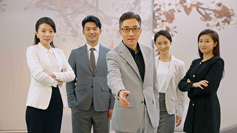 Confident Chinese business people standing in office