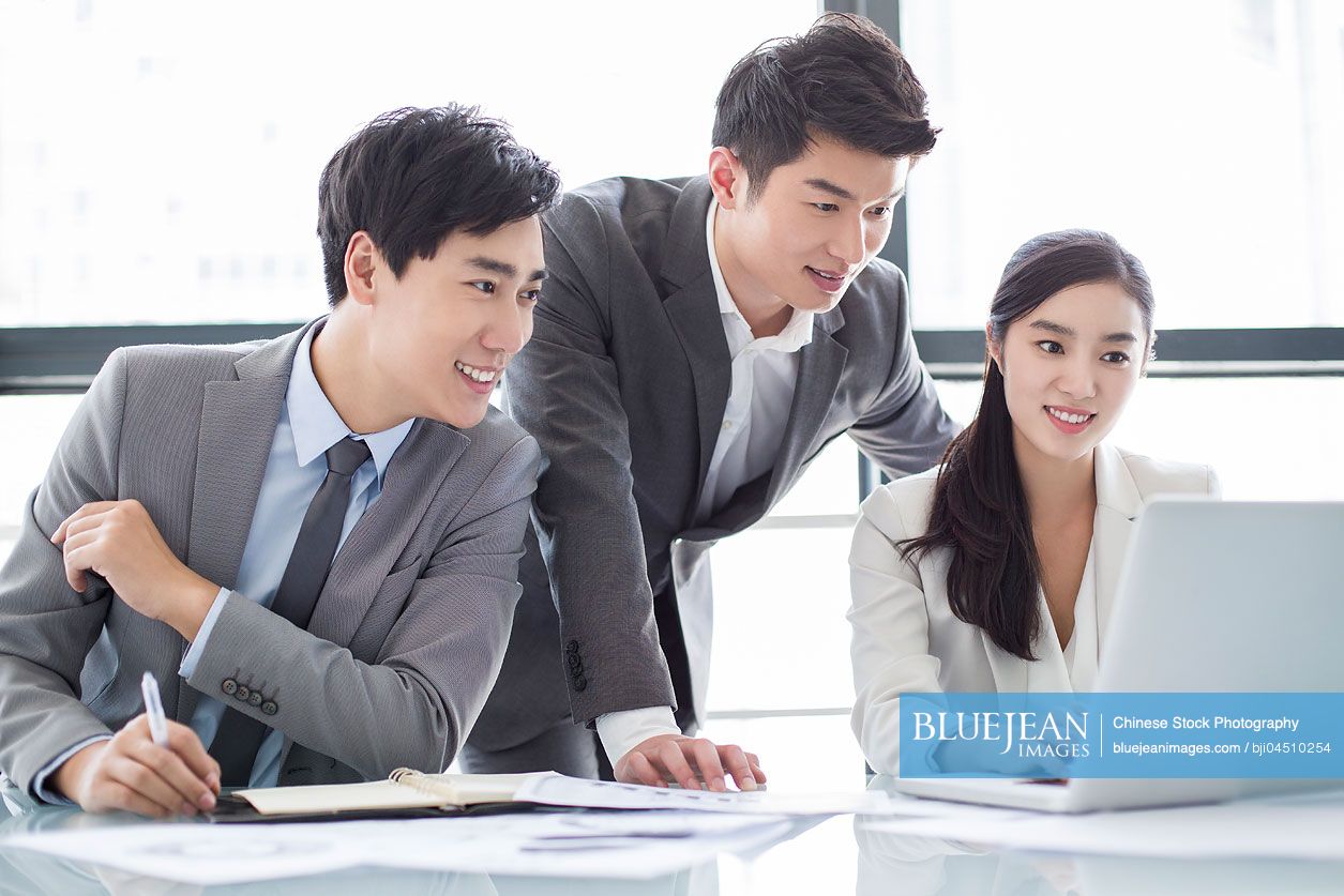 Young Chinese business person talking in meeting