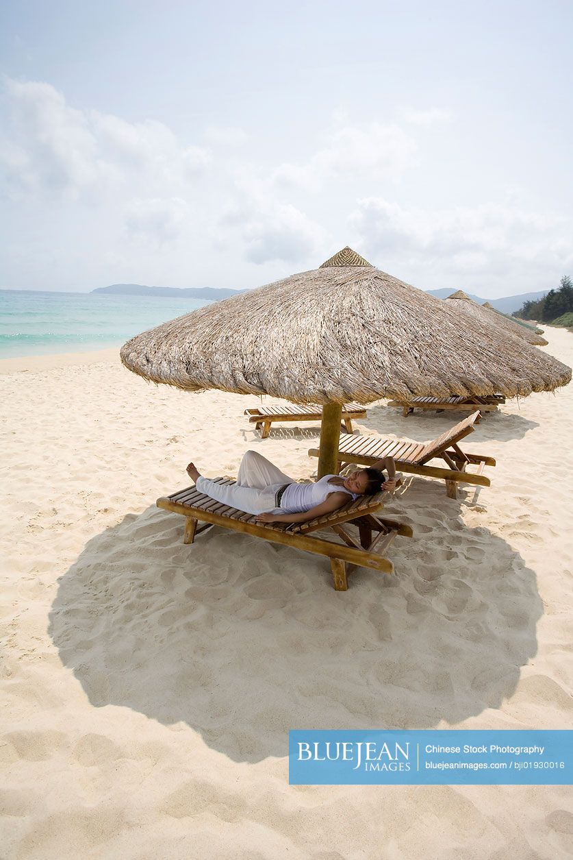 Young Chinese woman relaxing on the beach