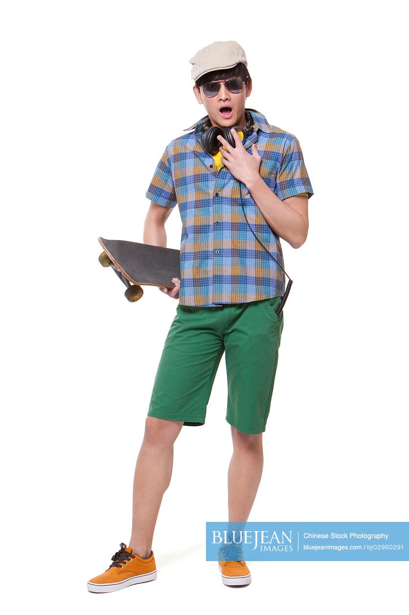 Cool young Chinese man with skateboard