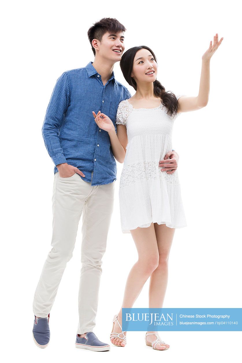 Happy young Chinese couple looking up