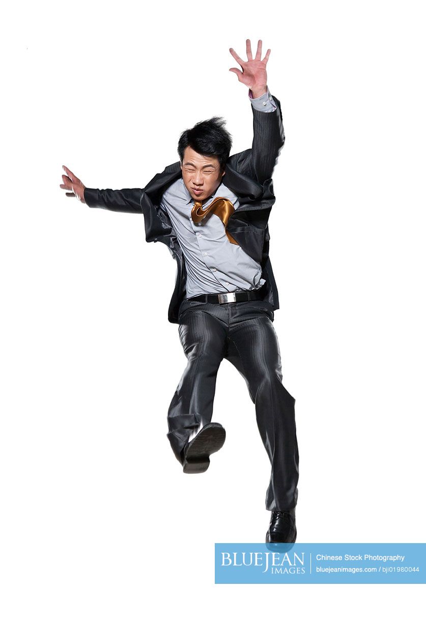 Chinese businessman jumping in the air