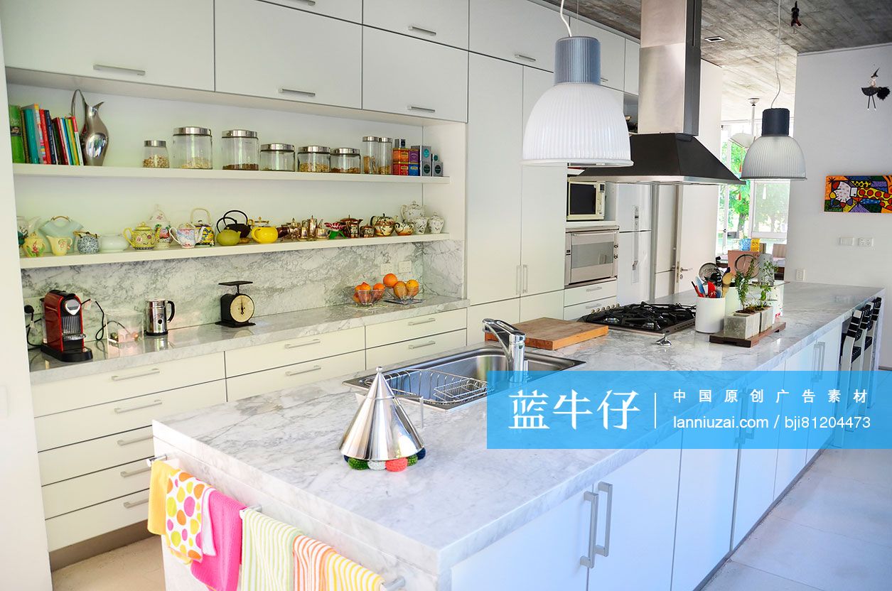 Marble kitchen island with cabinets in middle class home