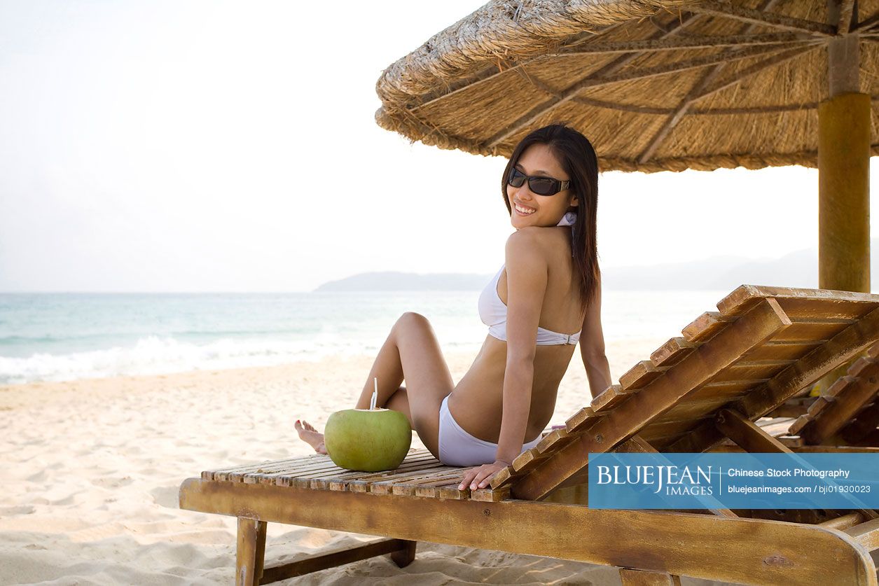 Young Chinese woman relaxing on the beach