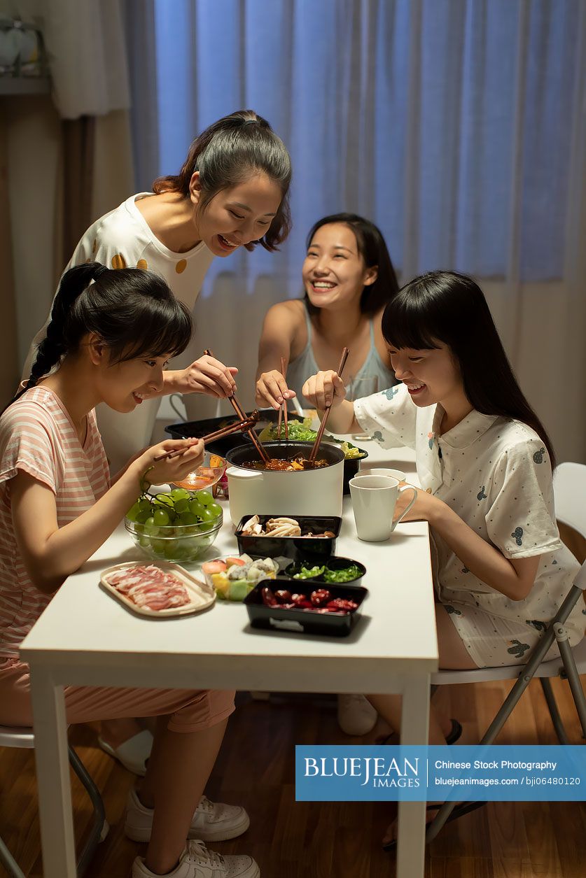 Young Chinese university students having chaffy dish in dormitory
