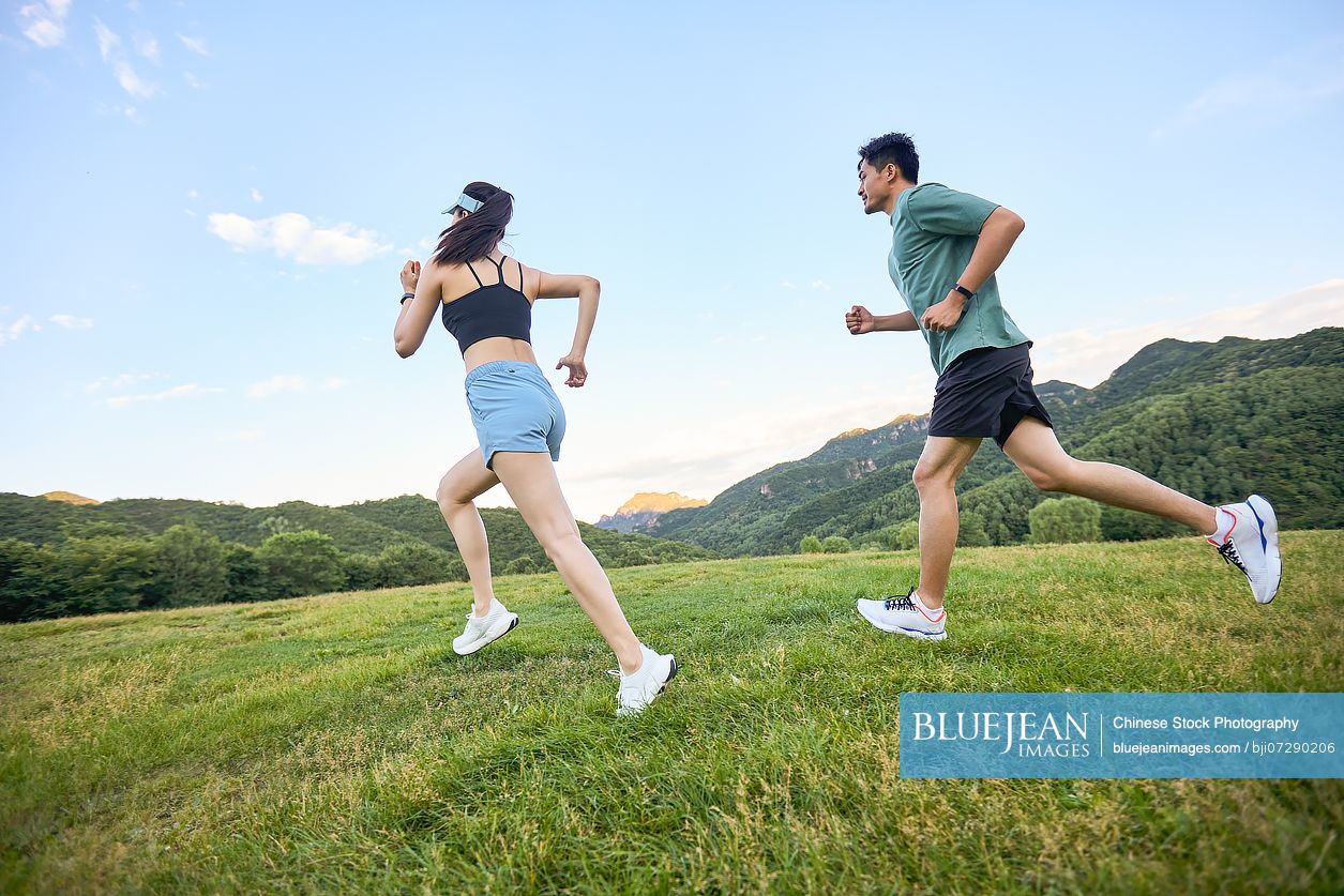 Young couple exercising in the heart of nature embracing the fresh air and natural surroundings