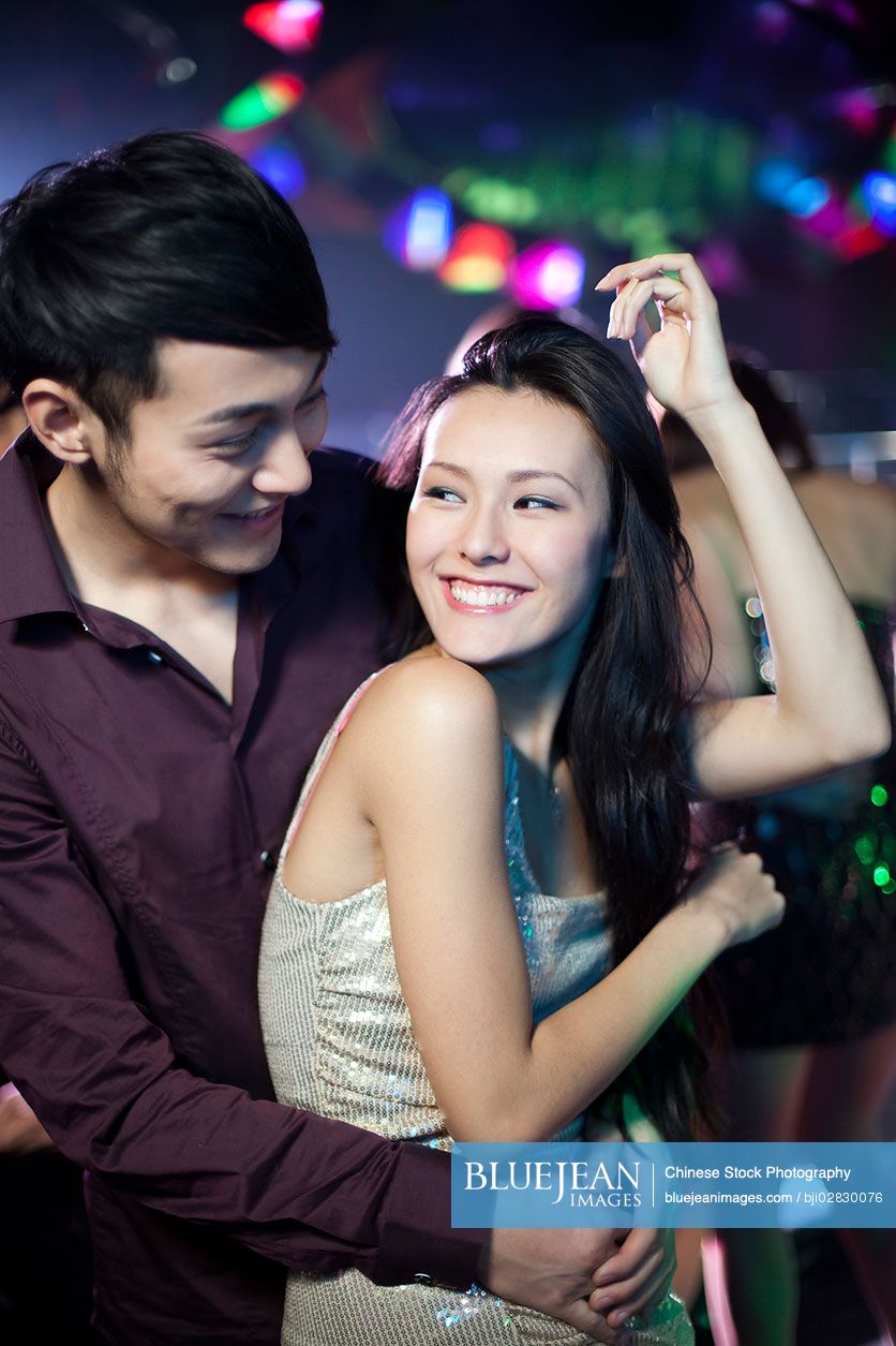 Stylish young Chinese dancing in nightclub
