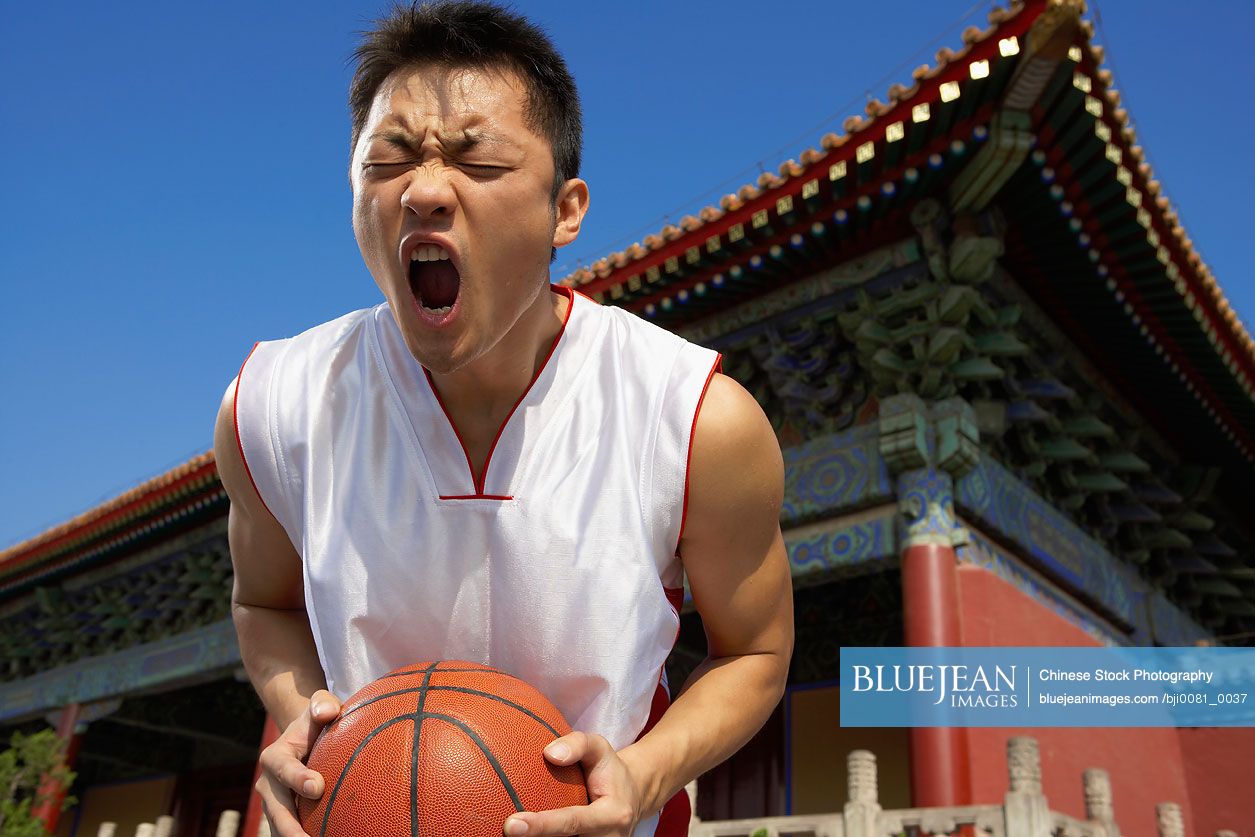 Portrait Of Young Chinese Basketball Player In Front Of Temple