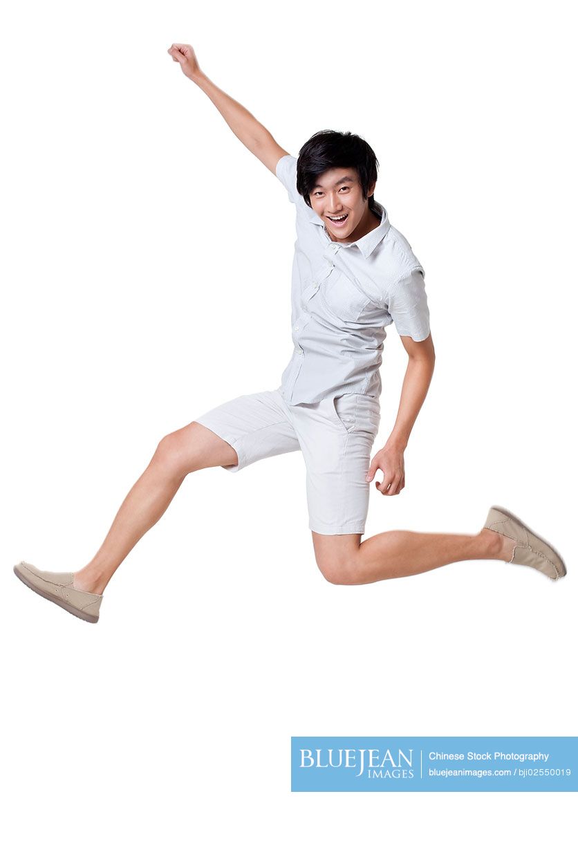 Young Chinese man jumping in the air