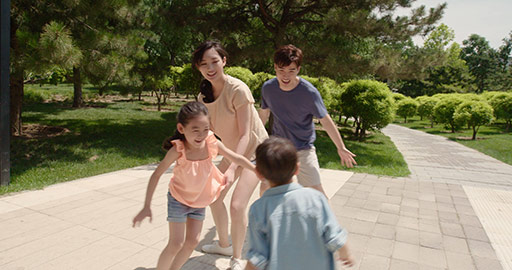 Happy young Chinese family playing in park,4K