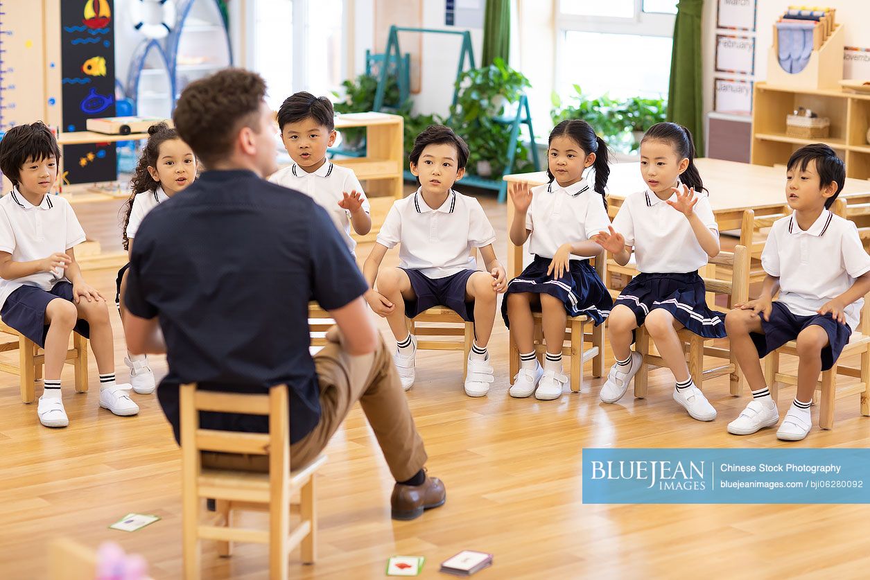 Foreign teacher teaching children English in classroom