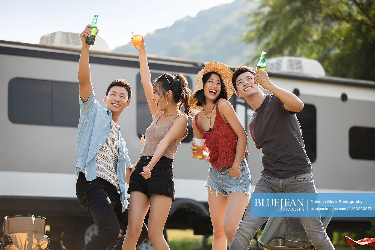 Happy young Chinese friends having fun outdoors
