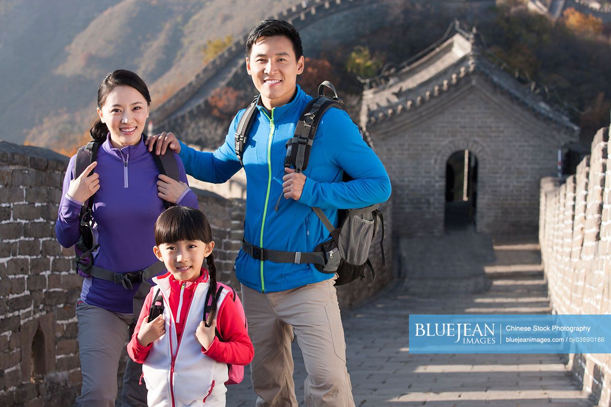 Young Chinese family enjoying autumn outing on Great Wall