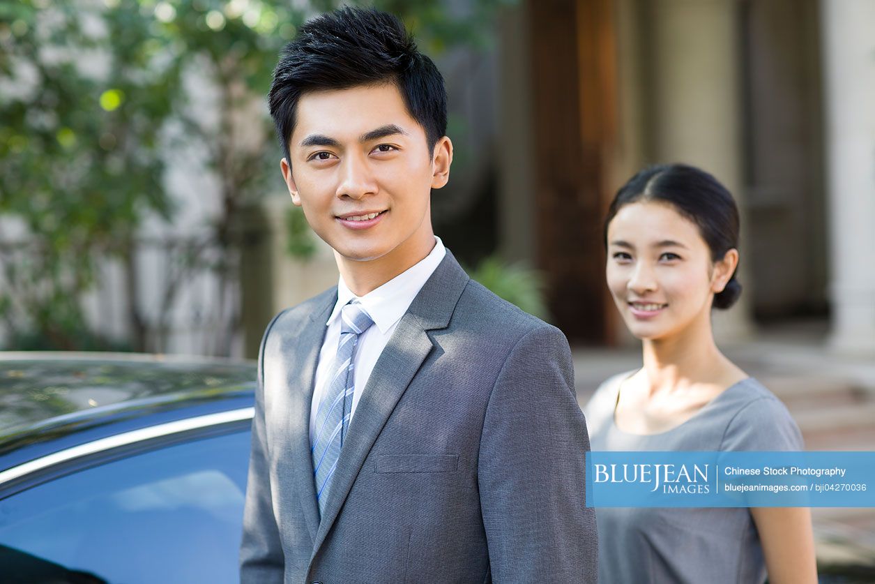 Young Chinese couple and car