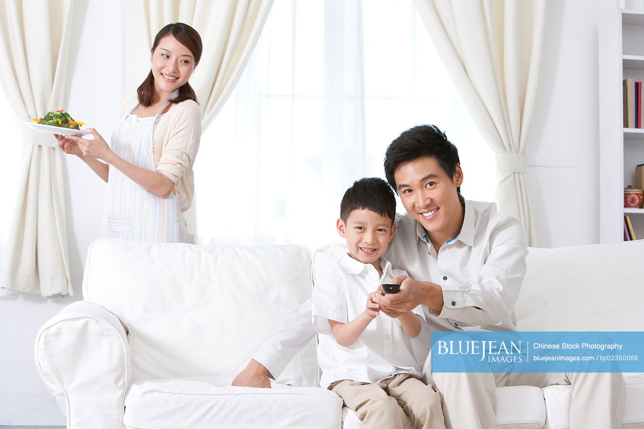 Chinese family relaxing in living room