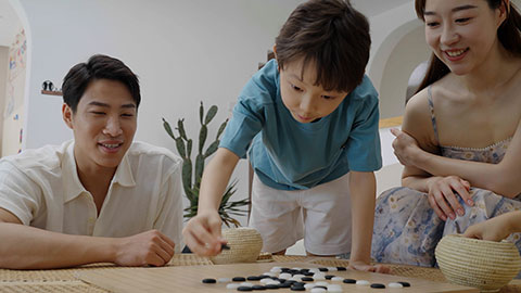 Family enjoying a game of Go in the hotel room