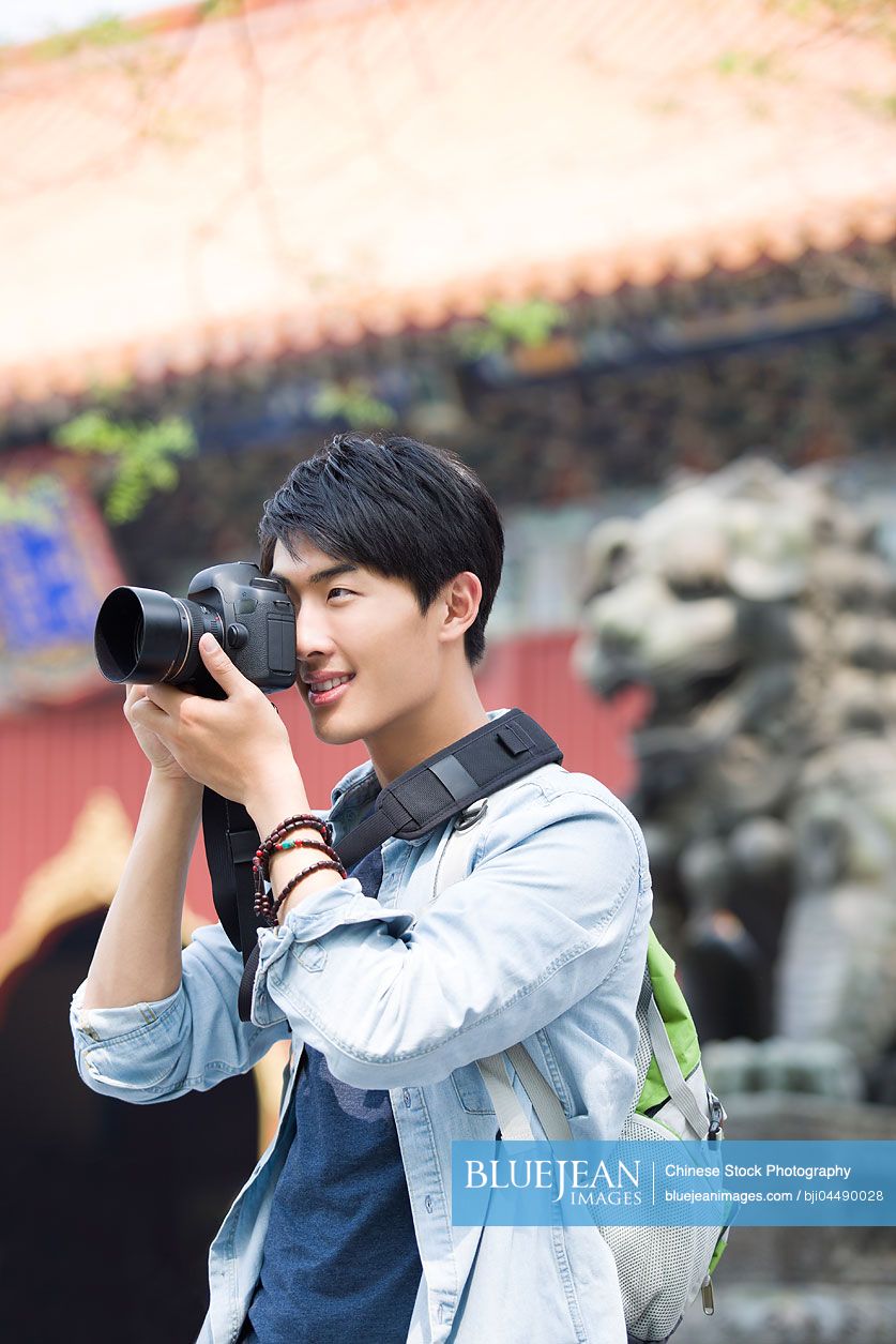 Young Chinese man taking pictures in the Lama Temple
