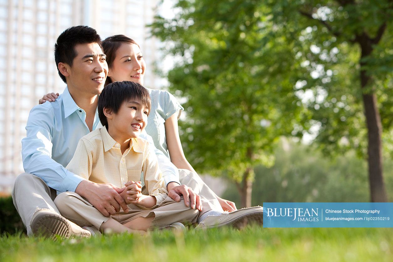 Chinese family relaxing in the park