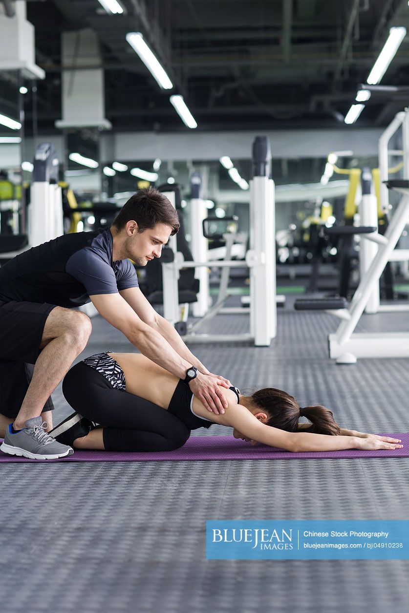 Young Chinese woman working with trainer at gym-High-res stock photo ...