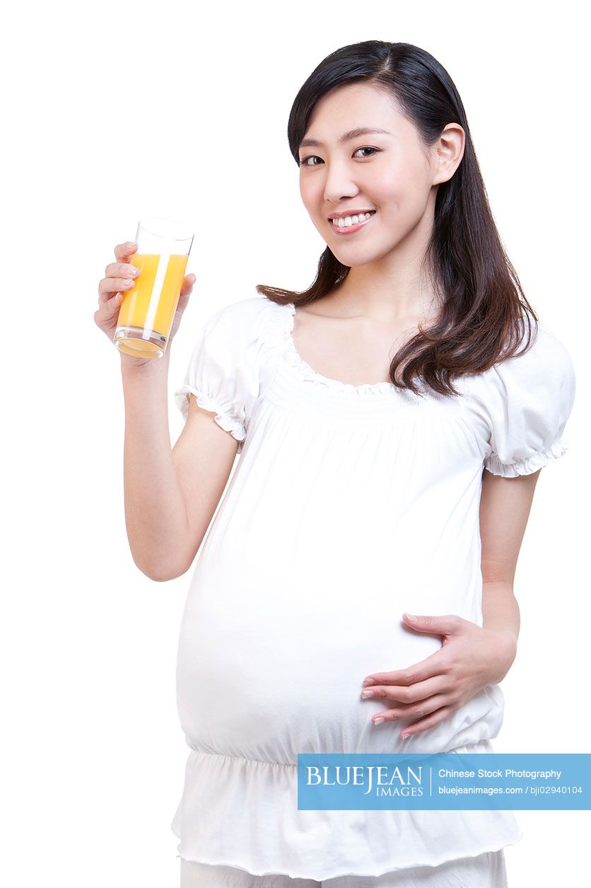 Pregnant young Chinese woman and orange juice