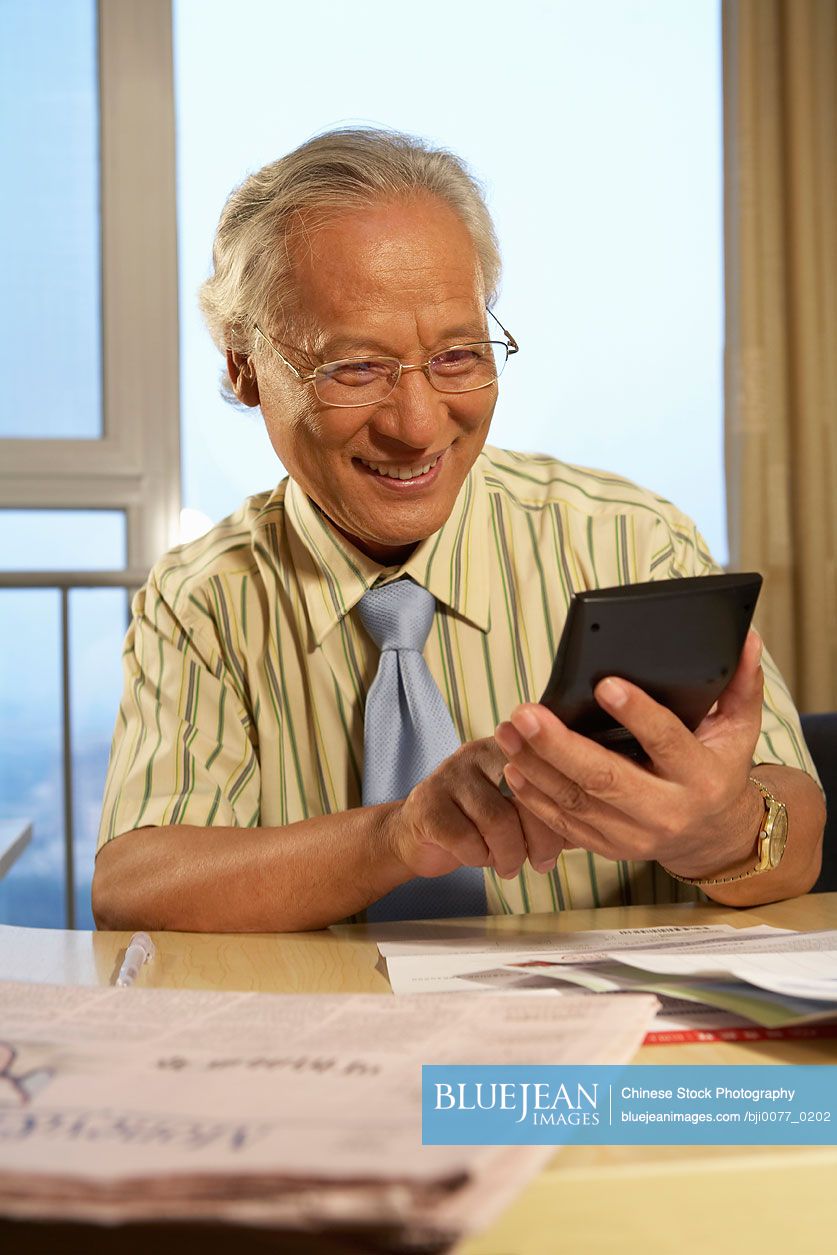Chinese Businessman Using Calculator
