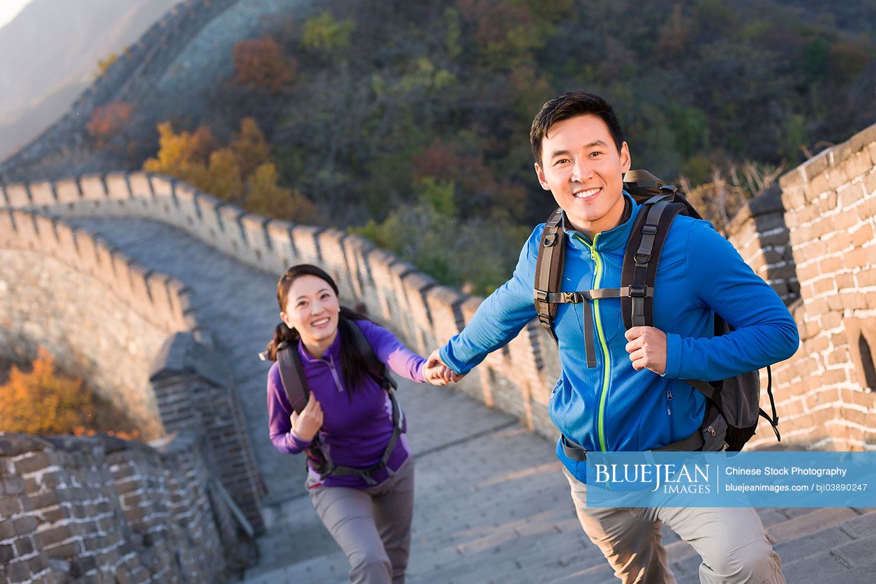 Young Chinese couple enjoying autumn outing on Great Wall