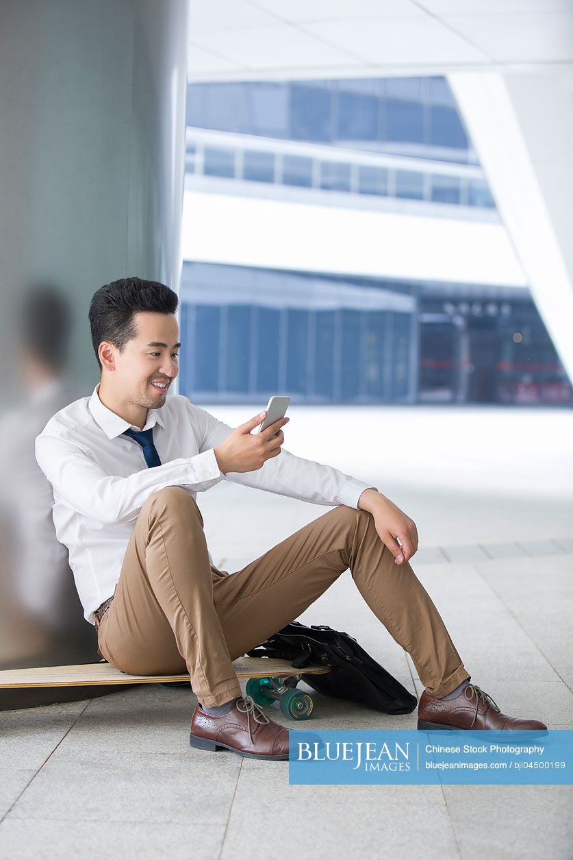 Chinese businessman using smart phone