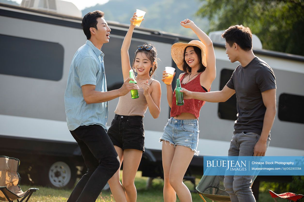 Happy young Chinese friends having fun outdoors