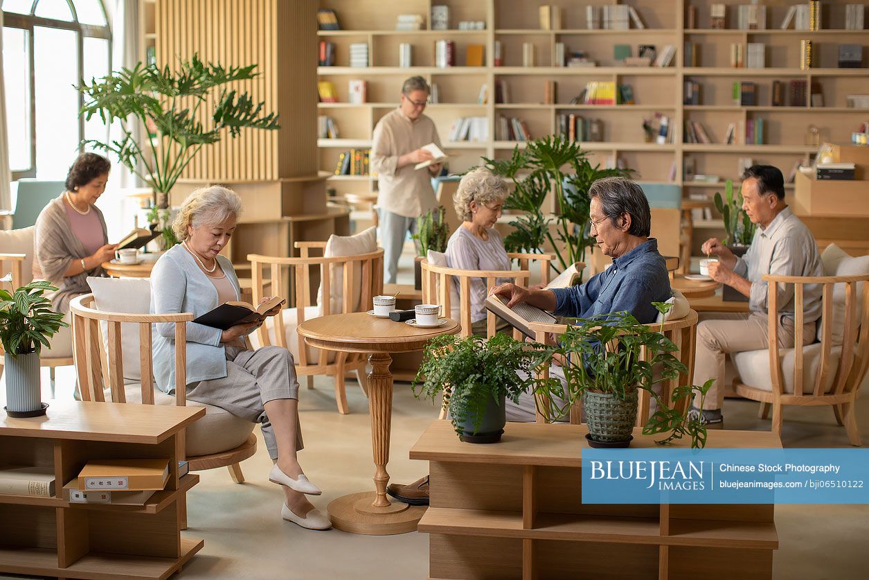 Senior Chinese adult reading books in book club