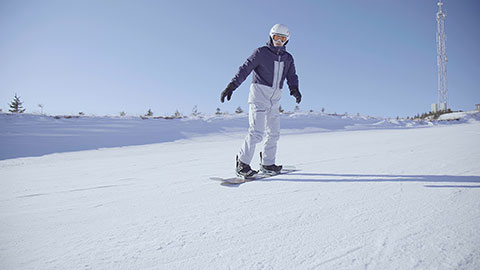 Young Chinese man snowboarding in ski resort,4K