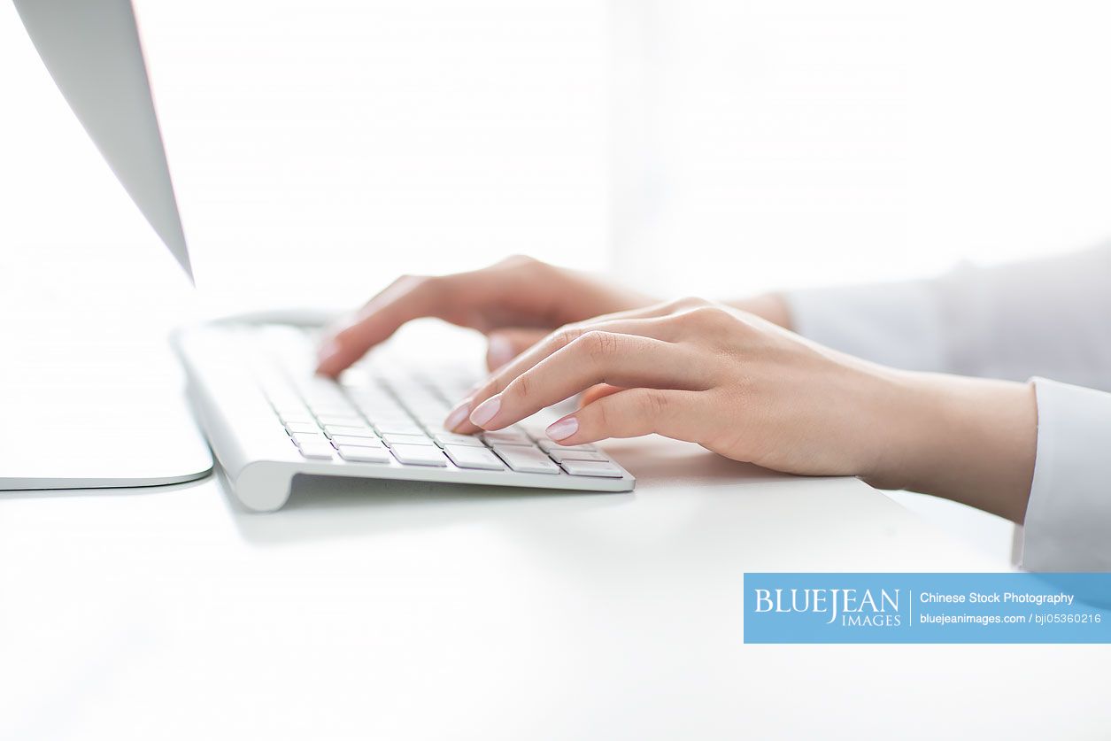 Young Chinese businesswoman using computer in office