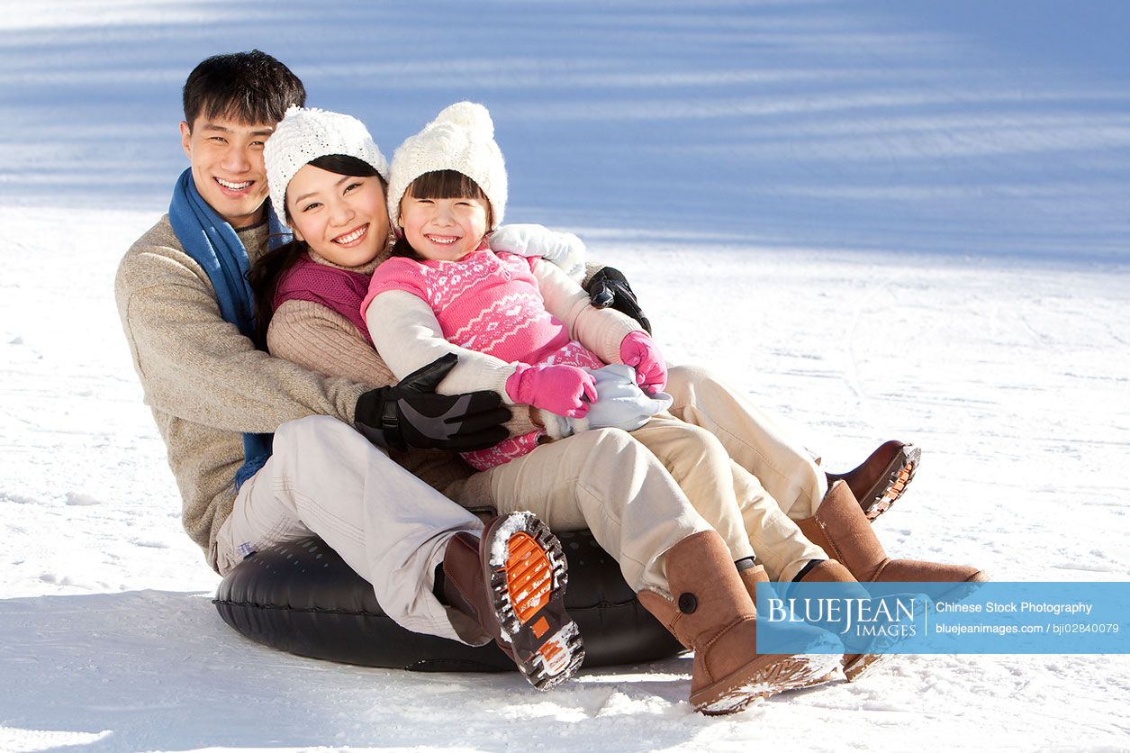 Chinese family having fun in snow