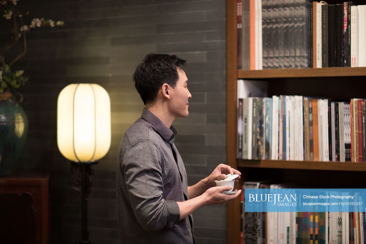 Mid adult Chinese man drinking tea