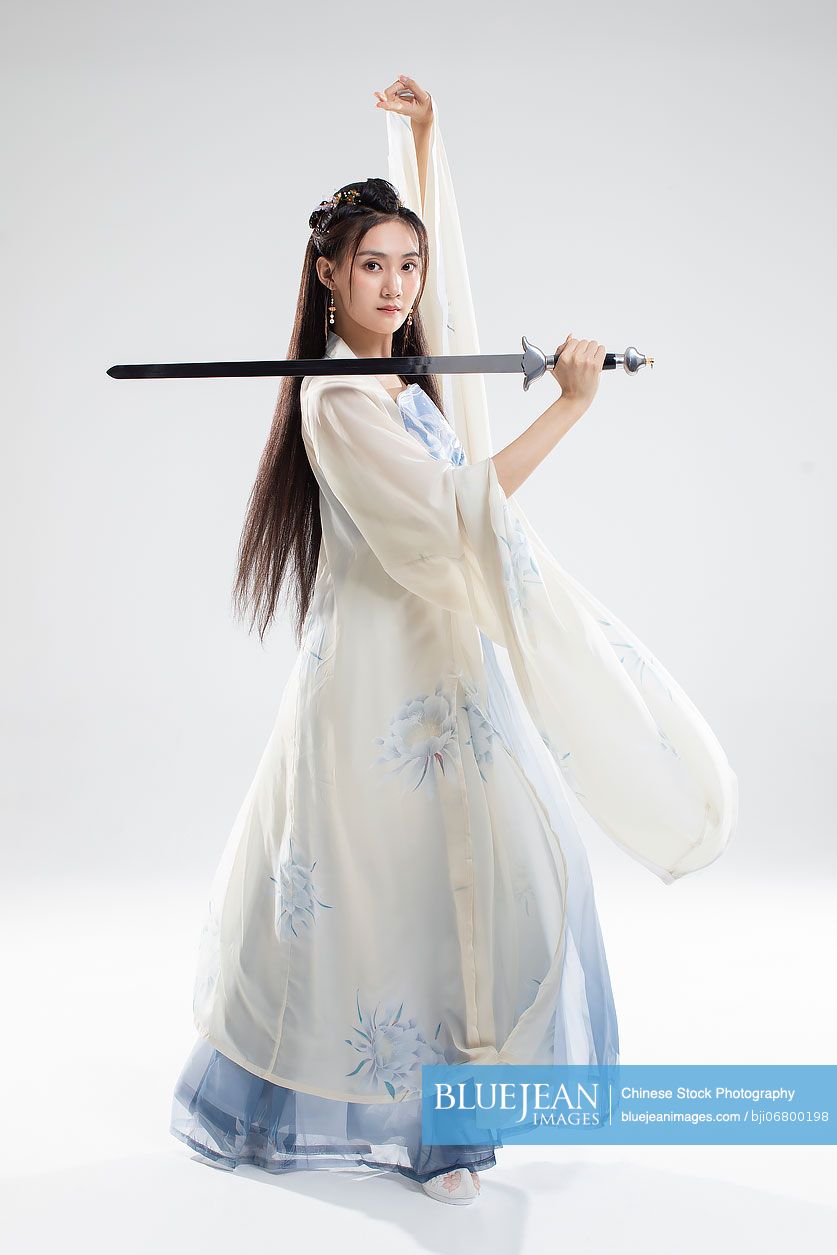 Young Chinese woman in ancient costume holding a sword