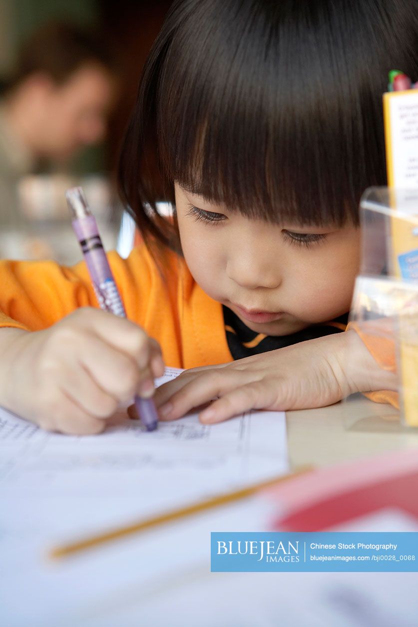 Small Chinese girl learning to write